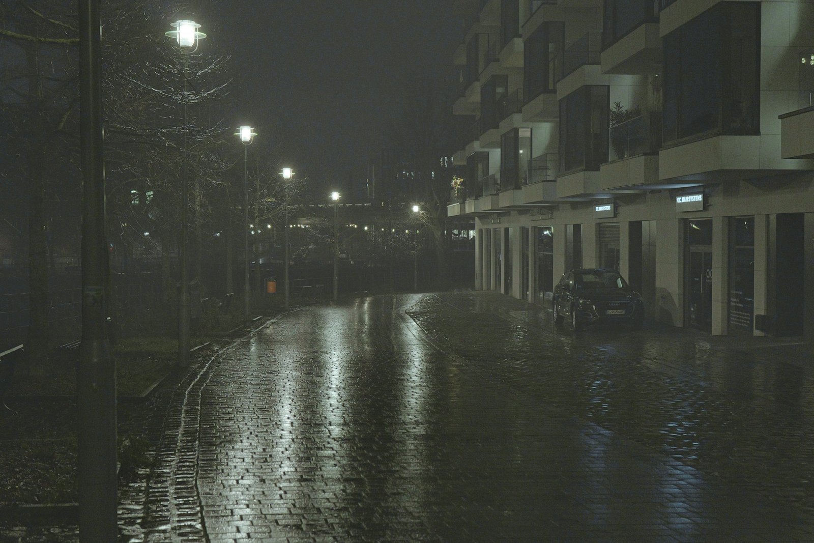 rainy street at night with lamp reflections