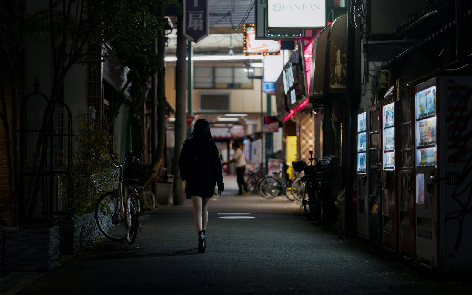 person walking alone down quiet night street